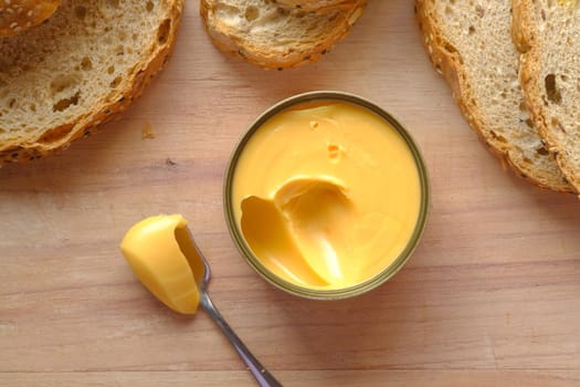 cheddar cheese in a tin container on table .