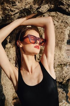 pretty woman in black swimsuit sunglasses posing sun. High quality photo