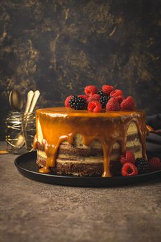 Delicious caramel cake with blackberries and raspberries.