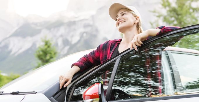 woman with car in the mountains.