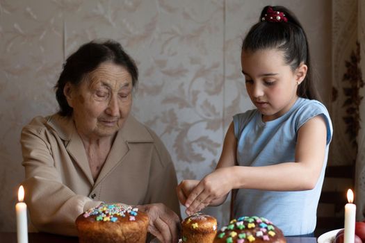 senior woman with easter eggs and Easter cake.