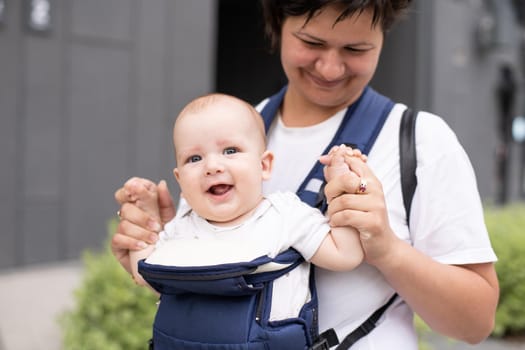 Portrait of beautiful happy smiling mother with baby outdoor.