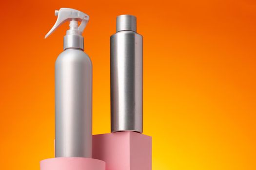 Skincare beauty products container against pink background, copy space