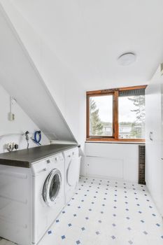 Luxurious laundry room with a window to the street