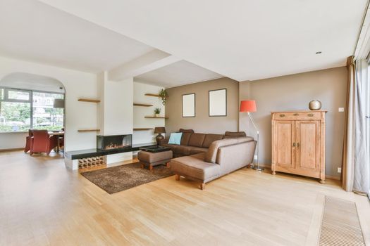 A chic and irresistible living room with a brown large low leather sofa