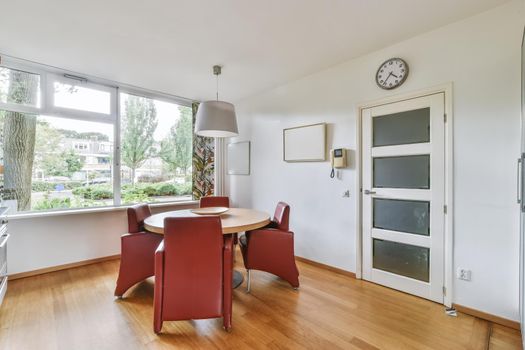 Luxurious dining room for four with red chairs