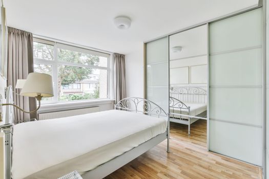 Cozy and elegant bedroom with full wall wardrobe
