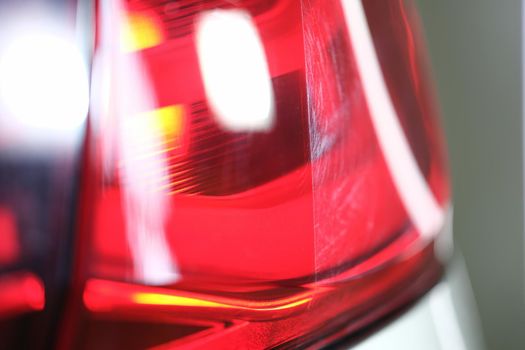 Bright red headlight of a car, close up. Light headlamp. Automotive optics polishing and repair, parts replacement