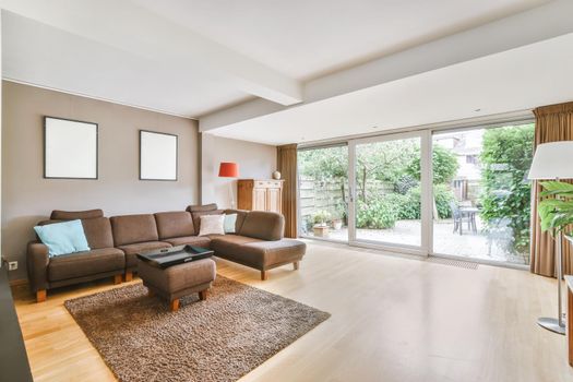 A chic and irresistible living room with a brown large low leather sofa