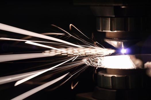 Stream of sparks from cutting metal, flash, close-up. Scrap metal sorting, laser cutting service, danger