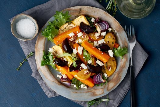 Vegetarian salad sheep cheese, baked roasted vegetables, keto ketogenic dash diet. Mix of carrots, beets, turnips, rutabaga, onions and nuts. Clean eating. Top view