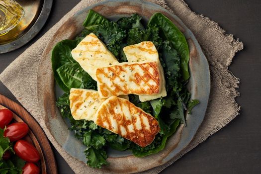 Keto, ketogenic diet. Cyprus fried halloumi cheese with healthy green salad. Lchf, pegan, fodmap, paleo, scd. Balanced food, a greek clean eating recipe, top view