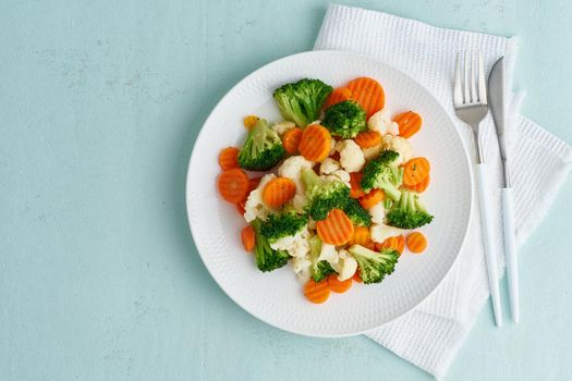 Mix of boiled vegetables. Broccoli, carrots, cauliflower. Steamed vegetables for dietary low-calorie diet. FODMAP, dash diet, vegan, vegetarian, top view, copy space