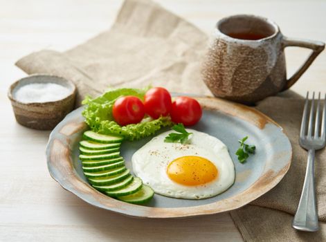 Fried egg, vegetables. Paleo, keto, fodmap diet. Copy space, side view.