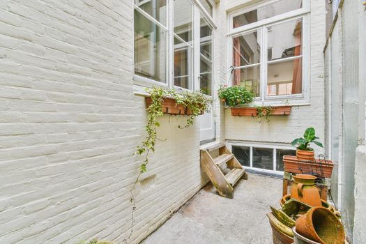 The courtyard of a beautiful house with flowers on pots