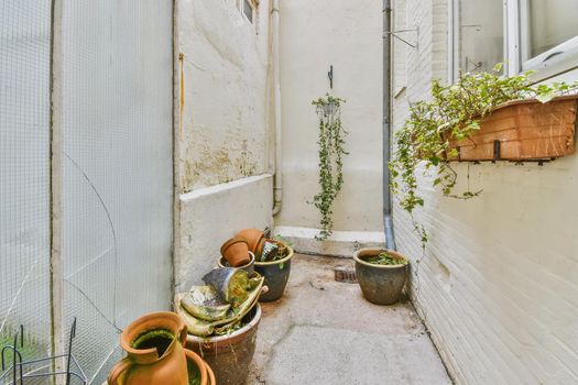 The courtyard of a beautiful house with flowers on pots
