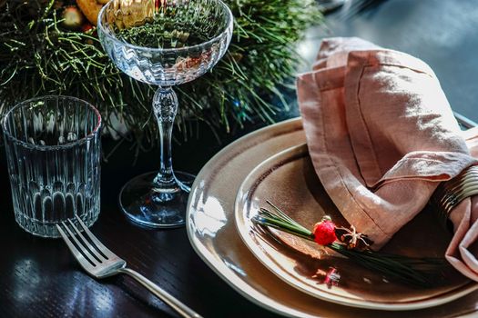 Table setting for festive Christmas dinner on black wooden table