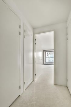 Interior of contemporary flat in minimal style with spacious hallway with white walls