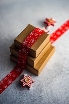 Holiday card concept with gift boxes and ribbon on concrete background