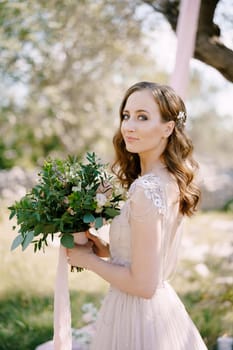Smiling bride with a bouquet of flowers. Portrait. High quality photo
