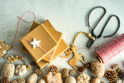 Holiday card concept with gift boxes and ribbon on concrete background