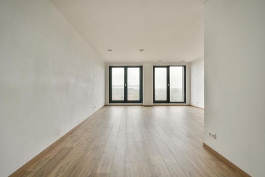 Modern room with wooden floor and white walls