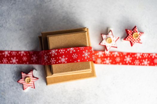 Holiday card concept with gift boxes and ribbon on concrete background