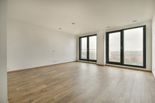 Modern room with wooden floor and white walls