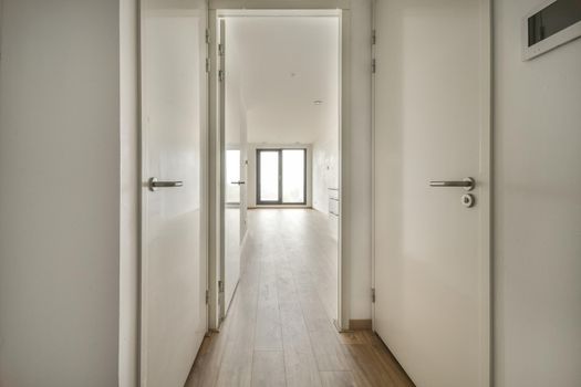 Interior of contemporary flat in minimal style with spacious hallway with white walls