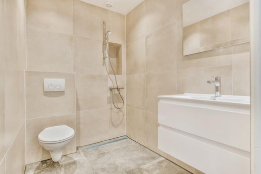 Stylish modern bathroom in beige tones with hanging toilet