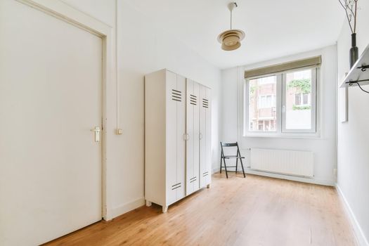 Small cozy room with a small window and a wooden floor