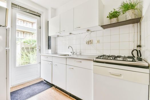 Large kitchen with white kitchen unit and parquet floor