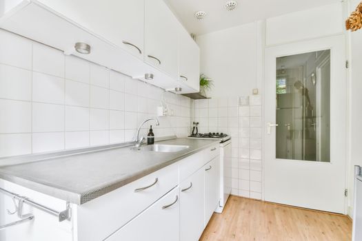 Large kitchen with white kitchen unit and parquet floor