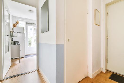 Delicate corner corridor with paintings hanging on the wall