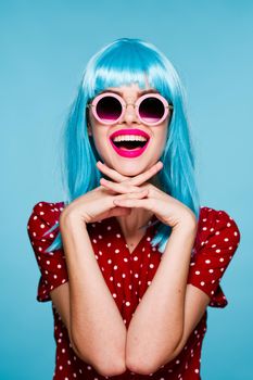 emotional glamorous woman on blue wig fashion glasses posing. High quality photo