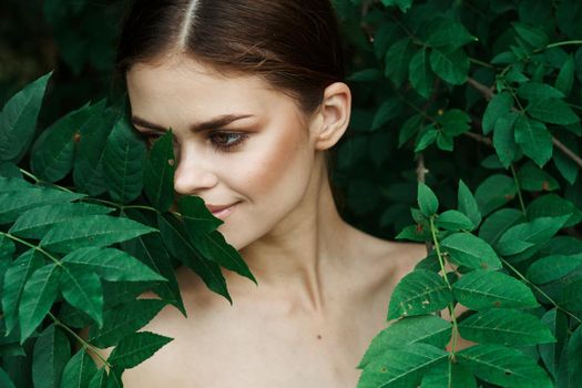 beautiful woman skin care bare shoulders green leaves nature Lifestyle. High quality photo