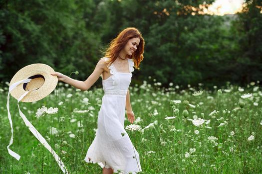 pretty woman in a field in nature white dress fresh air. High quality photo