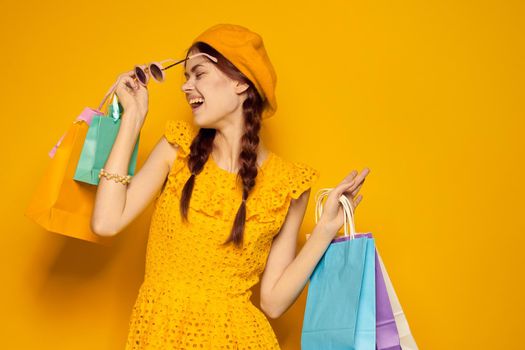 glamorous woman in a yellow hat Shopaholic fashion style isolated background. High quality photo