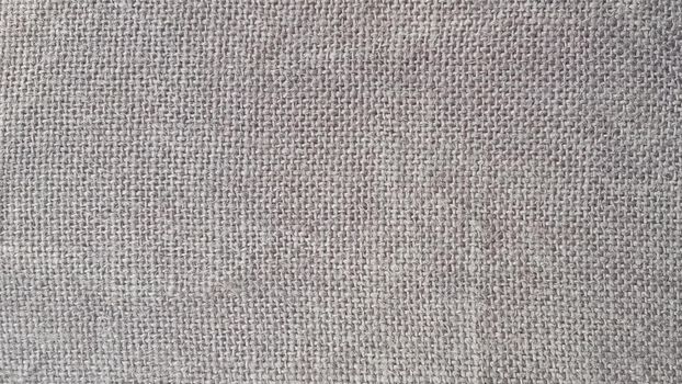 Tileable Burlap Texture. Background with a burlap texture. Grey Hessian burlap texture is useful as a background.