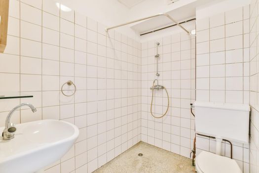 Bright bathroom with white tiles on all walls