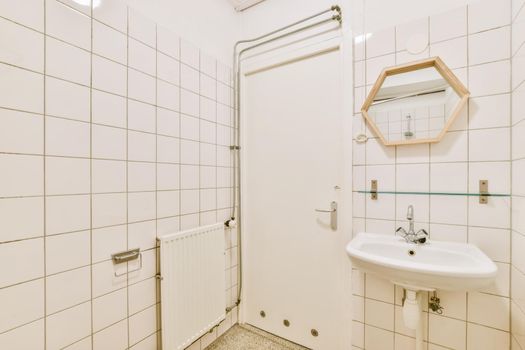 Bright bathroom with white tiles on all walls