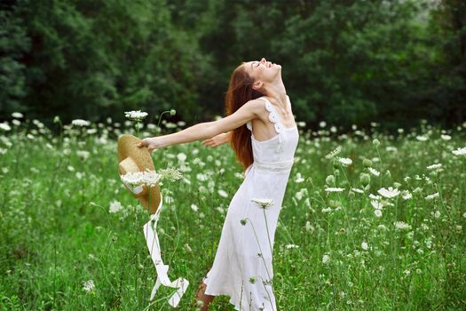 cheerful woman in a field outdoors flowers fresh air freedom. High quality photo
