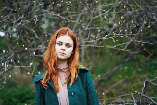 woman in green coat nature walk freedom fresh air. High quality photo