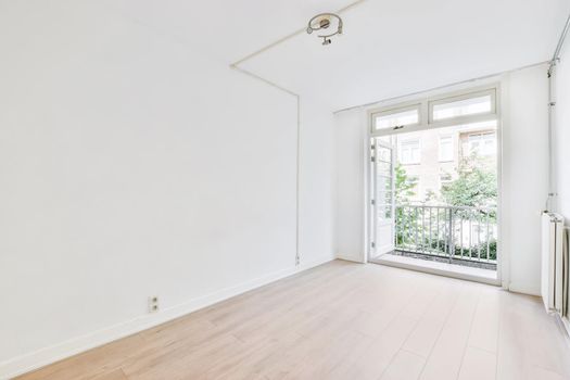 Bright room with open doors leading to the balcony