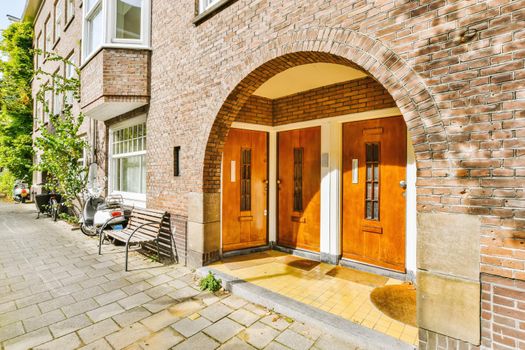 The entrance of the building with wooden doors