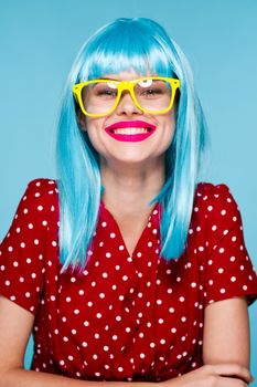 glamorous woman in blue wig yellow glasses posing model. High quality photo