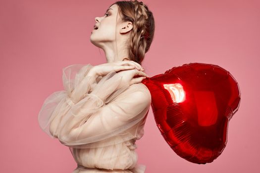 portrait of a woman red heart in the hands of the balloon isolated background. High quality photo