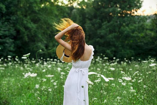 pretty woman in a field in nature white dress fresh air. High quality photo