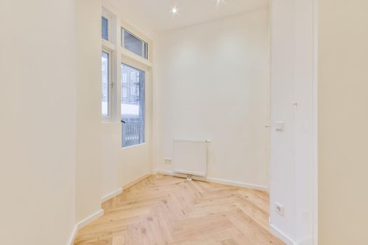 Modern room with wooden floor and white walls