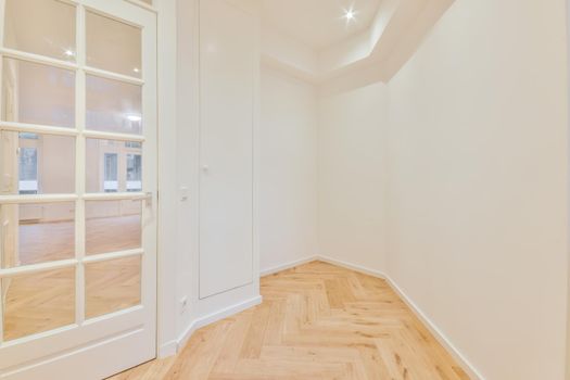 Modern room with wooden floor and white walls